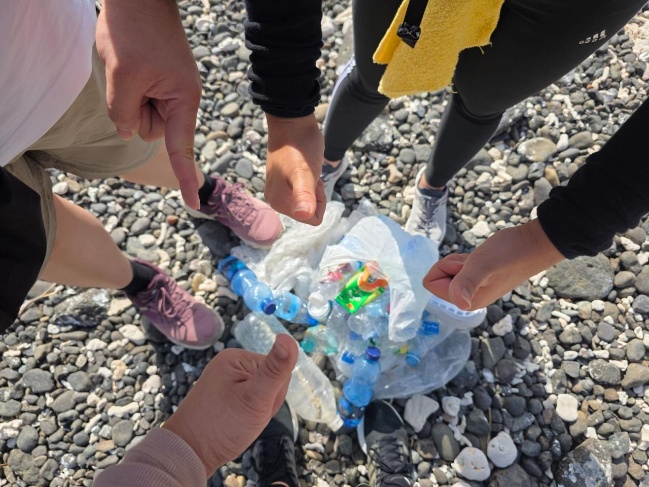 Team collecting plastic waste on a trail