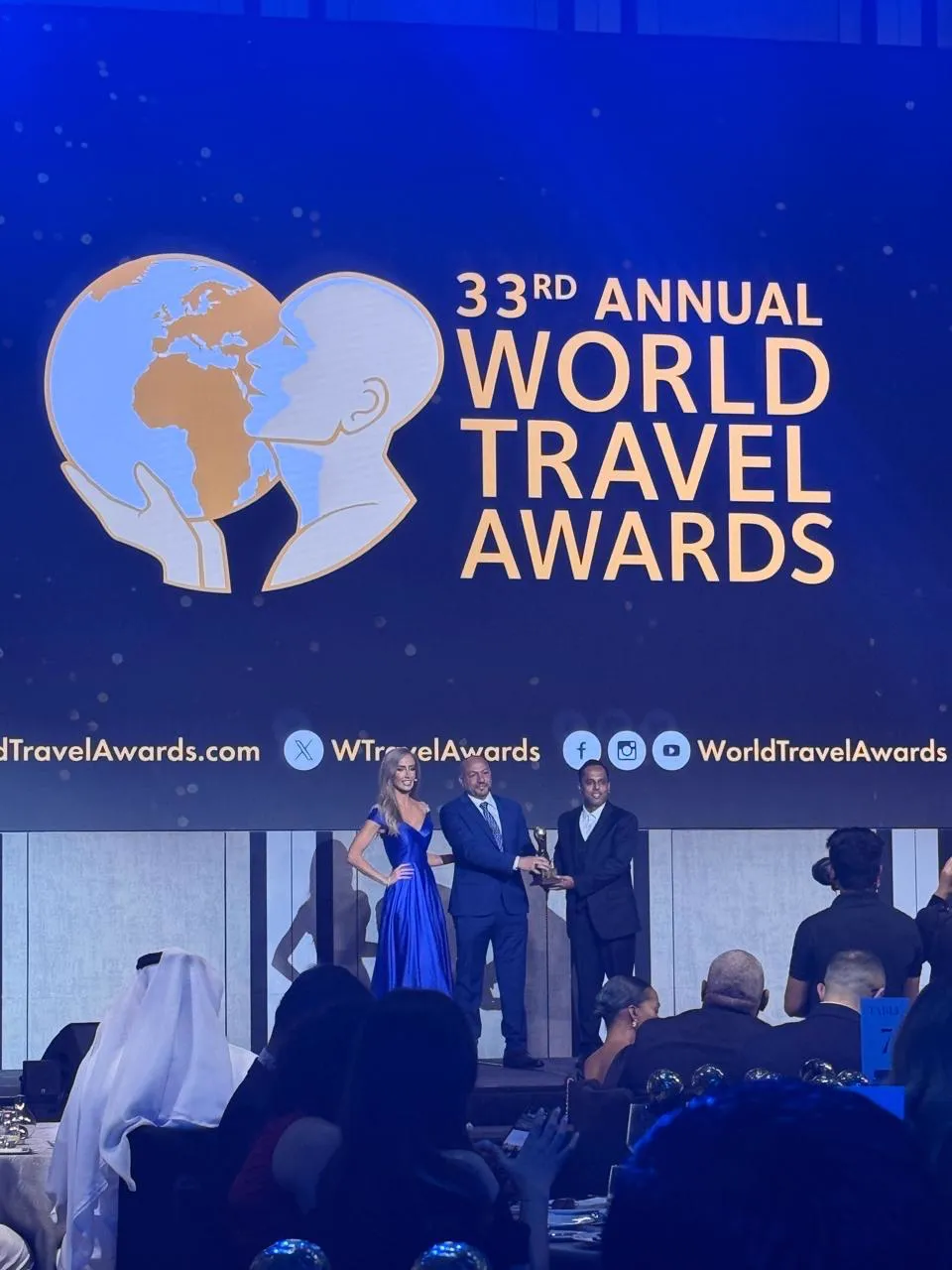Accepting a trophy on stage at the 33rd Annual World Travel Awards