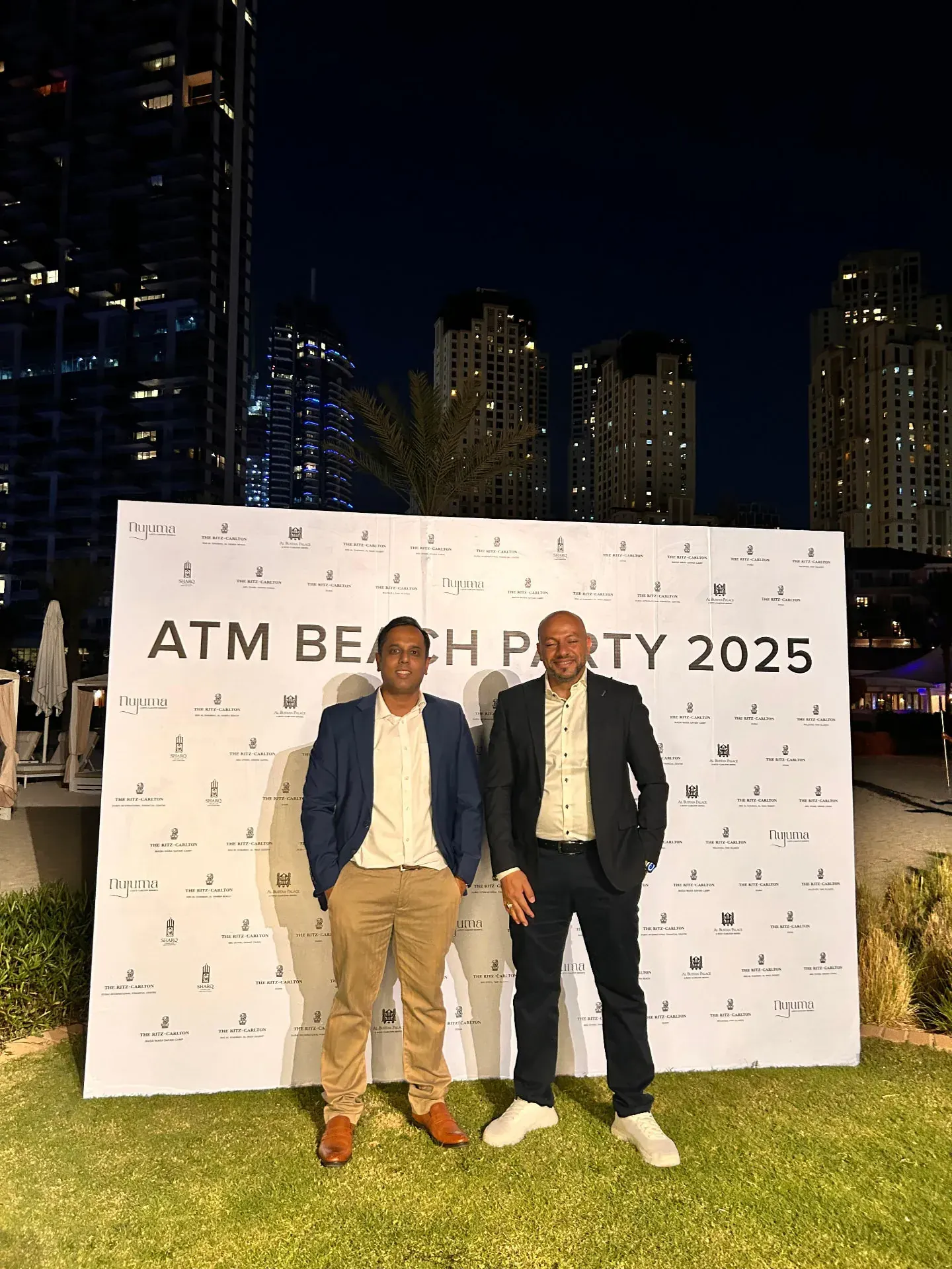 Representatives in front of the ATM Beach Party 2025 backdrop