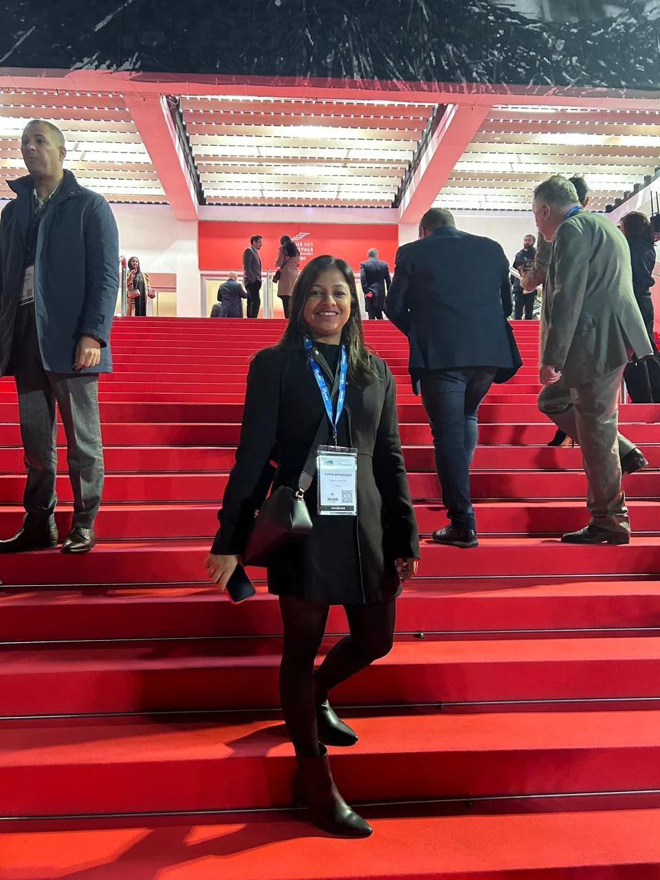 Delegate arriving on the red-carpet staircase