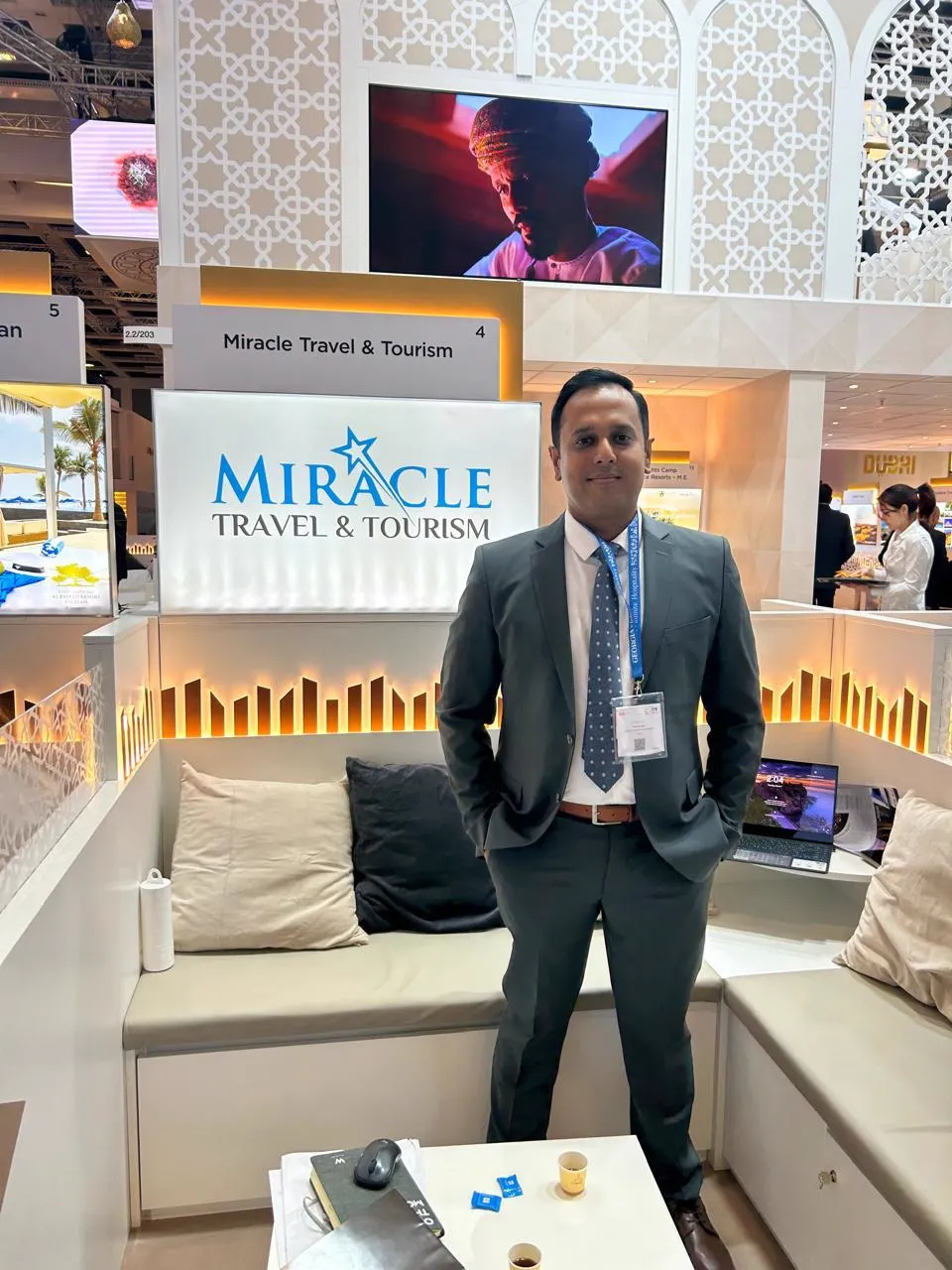 Team representative at the Miracle Travel & Tourism stand at a travel trade show