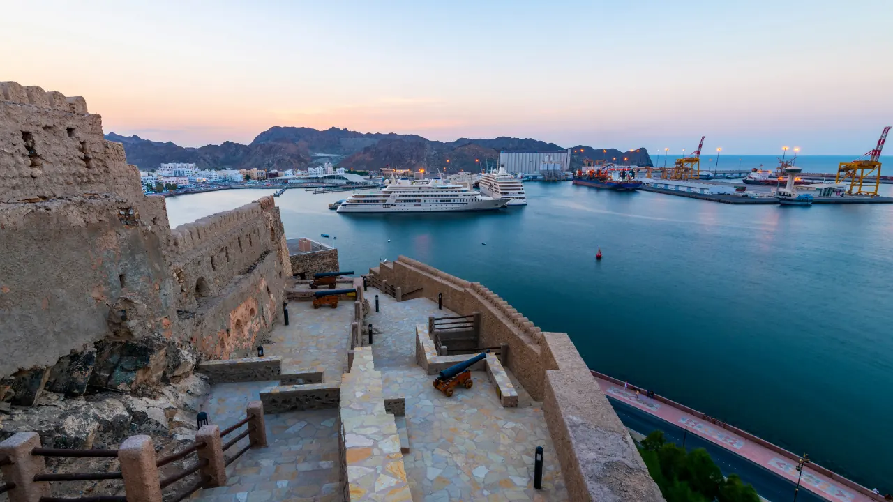 Mountain-framed harbour with waterfront buildings and boats
