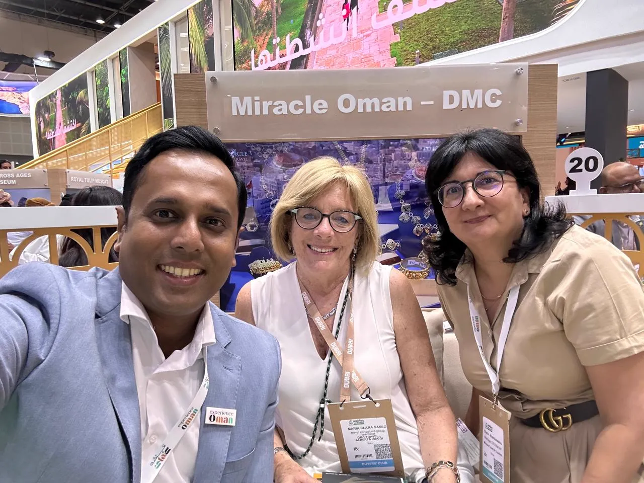 Team member with partners at the Miracle Oman DMC stand